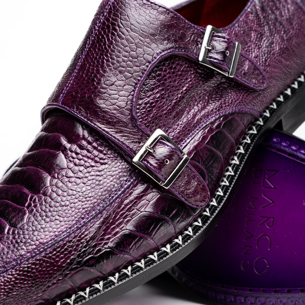 The Marco Di Milano Napoli Purple dress shoes feature genuine ostrich leather, a double monk strap, and textured detailing, with one shoe shown on its side to highlight the sole.