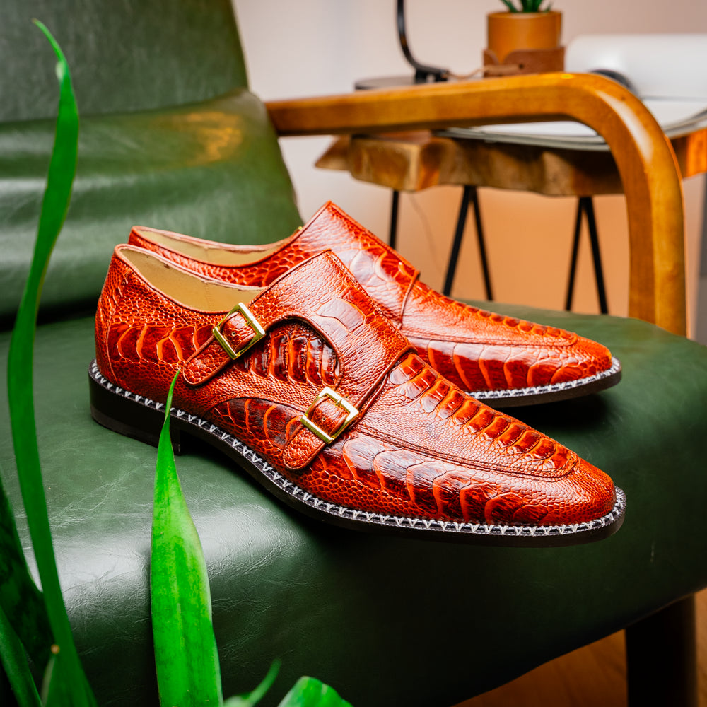 A pair of Marco Di Milano Napoli Rustic Cognac double monk strap dress shoes in genuine ostrich leg leather, with one shoe upright and the other on its side to show the sole.
