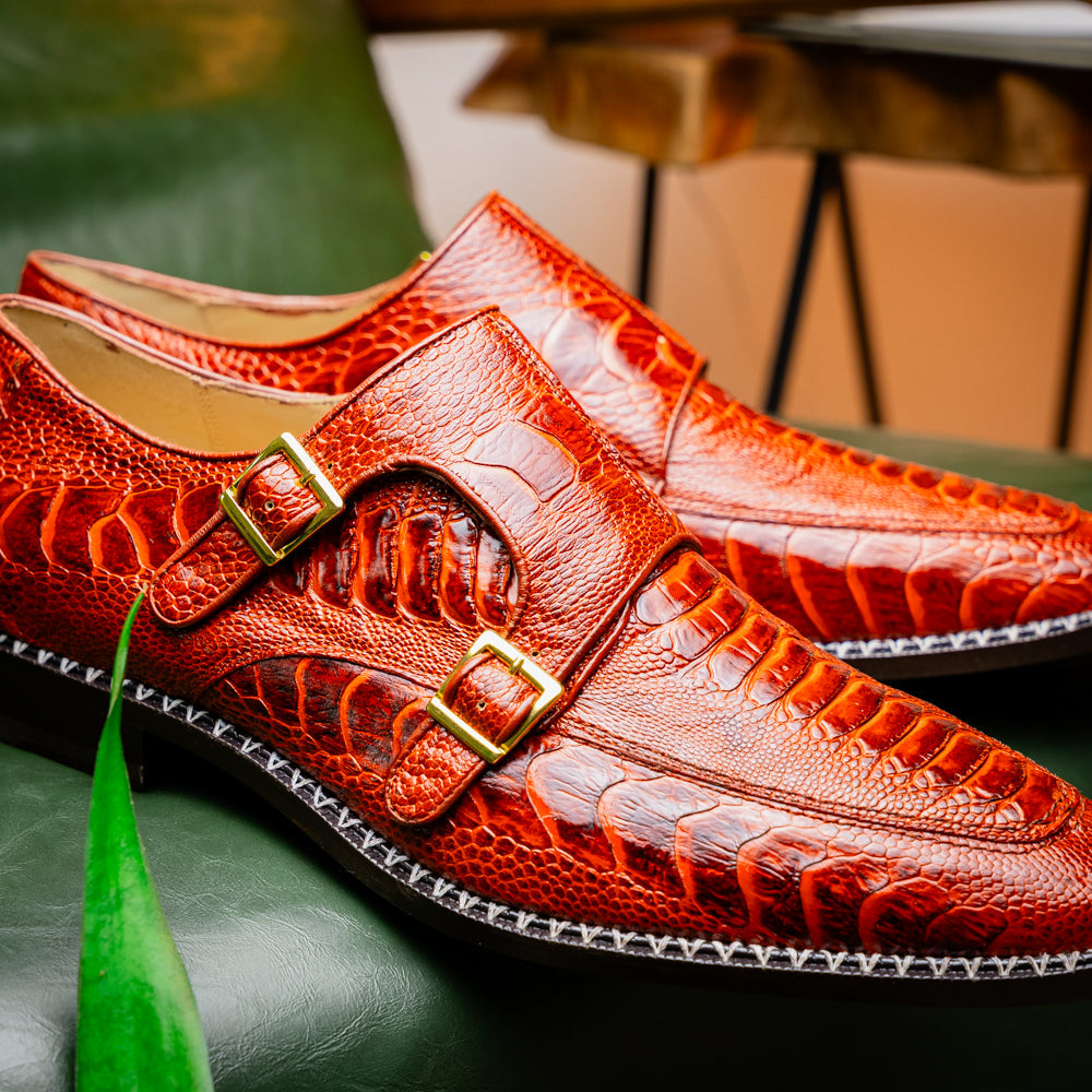 A pair of Marco Di Milano Napoli Rustic Cognac double monk strap dress shoes in genuine ostrich leg leather, with one shoe upright and the other on its side to show the sole.