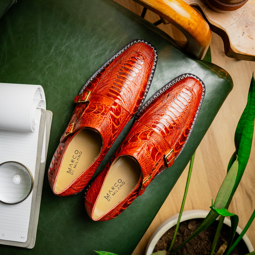 A pair of Marco Di Milano Napoli Rustic Cognac double monk strap dress shoes in genuine ostrich leg leather, with one shoe upright and the other on its side to show the sole.