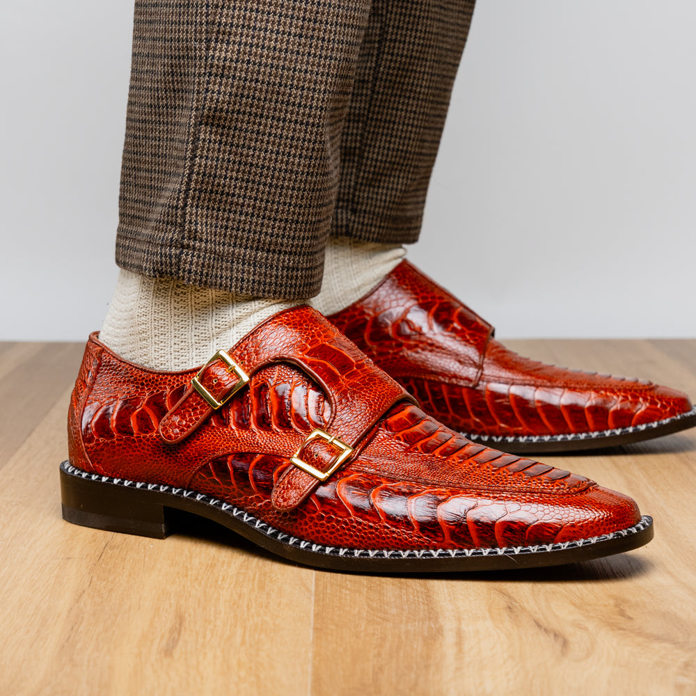 A pair of Marco Di Milano Napoli Rustic Cognac double monk strap dress shoes in genuine ostrich leg leather, with one shoe upright and the other on its side to show the sole.
