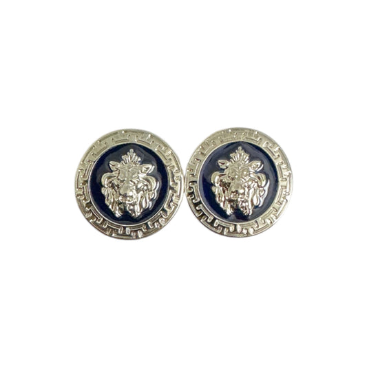 A pair of Matiste Navy/Silver Cufflinks by Matiste featuring round metallic buttons with a raised lion head design, inspired by Italian style, displayed on a dark background.