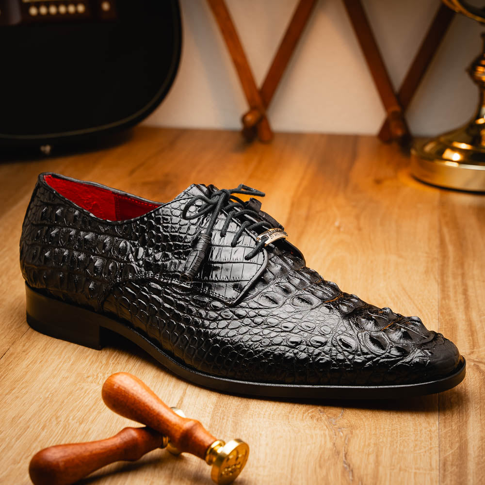 The Nilo Black by Marco Di Milano is a pair of luxury men's shoes made from polished black Nile crocodile skin with red inner lining and brown leather soles embossed with the brand name.
