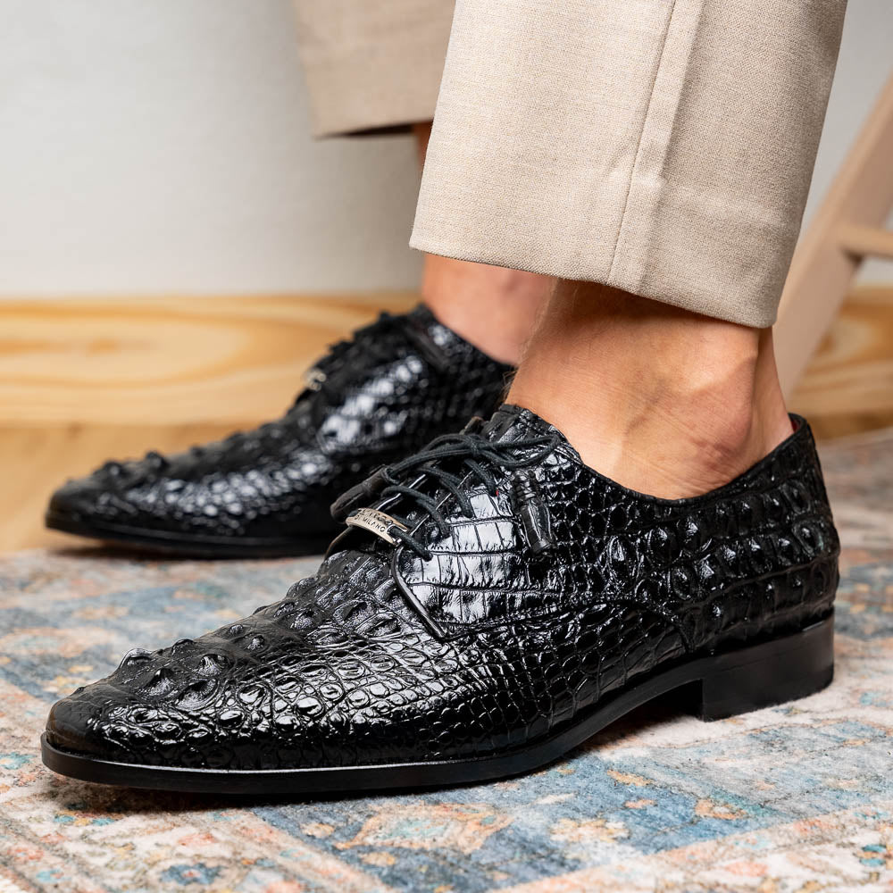 The Nilo Black by Marco Di Milano is a pair of luxury men's shoes made from polished black Nile crocodile skin with red inner lining and brown leather soles embossed with the brand name.