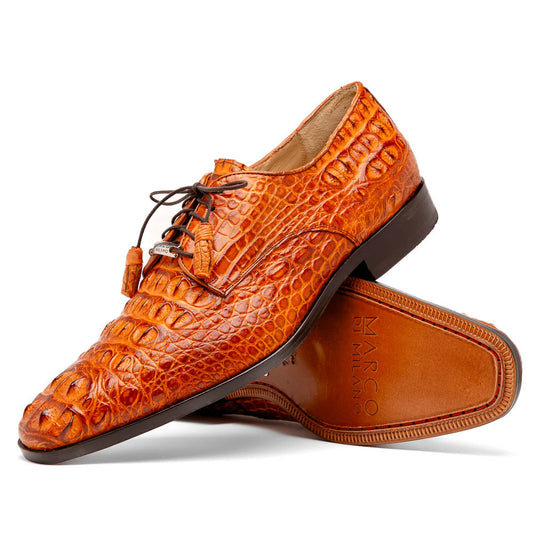 The Nilo Brandy by Marco Di Milano is a pair of orange luxury shoes made from Premium Nile Crocodile Skin with black laces—one shoe upright, the other flat to highlight its exquisite sole.