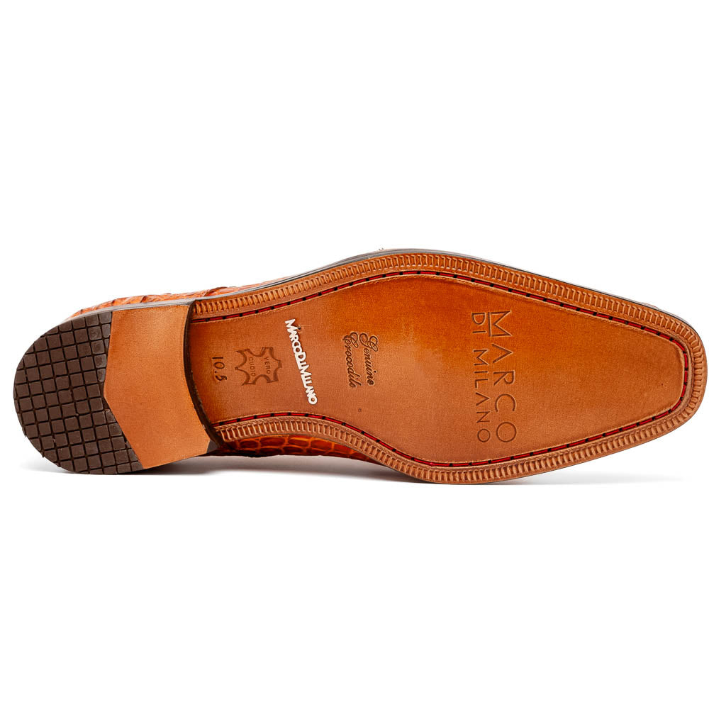The Nilo Brandy by Marco Di Milano is a pair of orange luxury shoes made from Premium Nile Crocodile Skin with black laces—one shoe upright, the other flat to highlight its exquisite sole.
