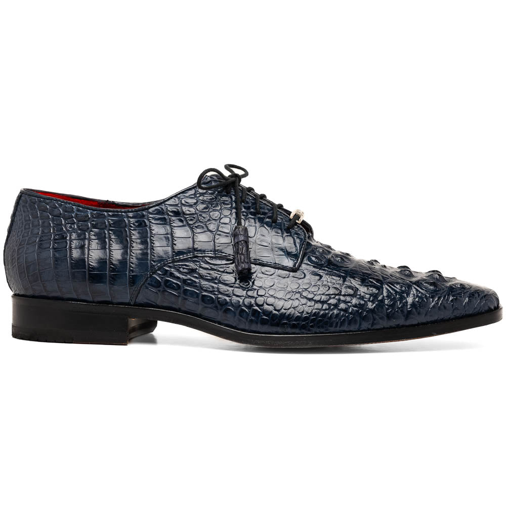The Nilo Navy by Marco Di Milano features dark blue luxury footwear crafted from premium Nile crocodile skin with black laces and brown leather soles, displayed with one shoe propped on the other.