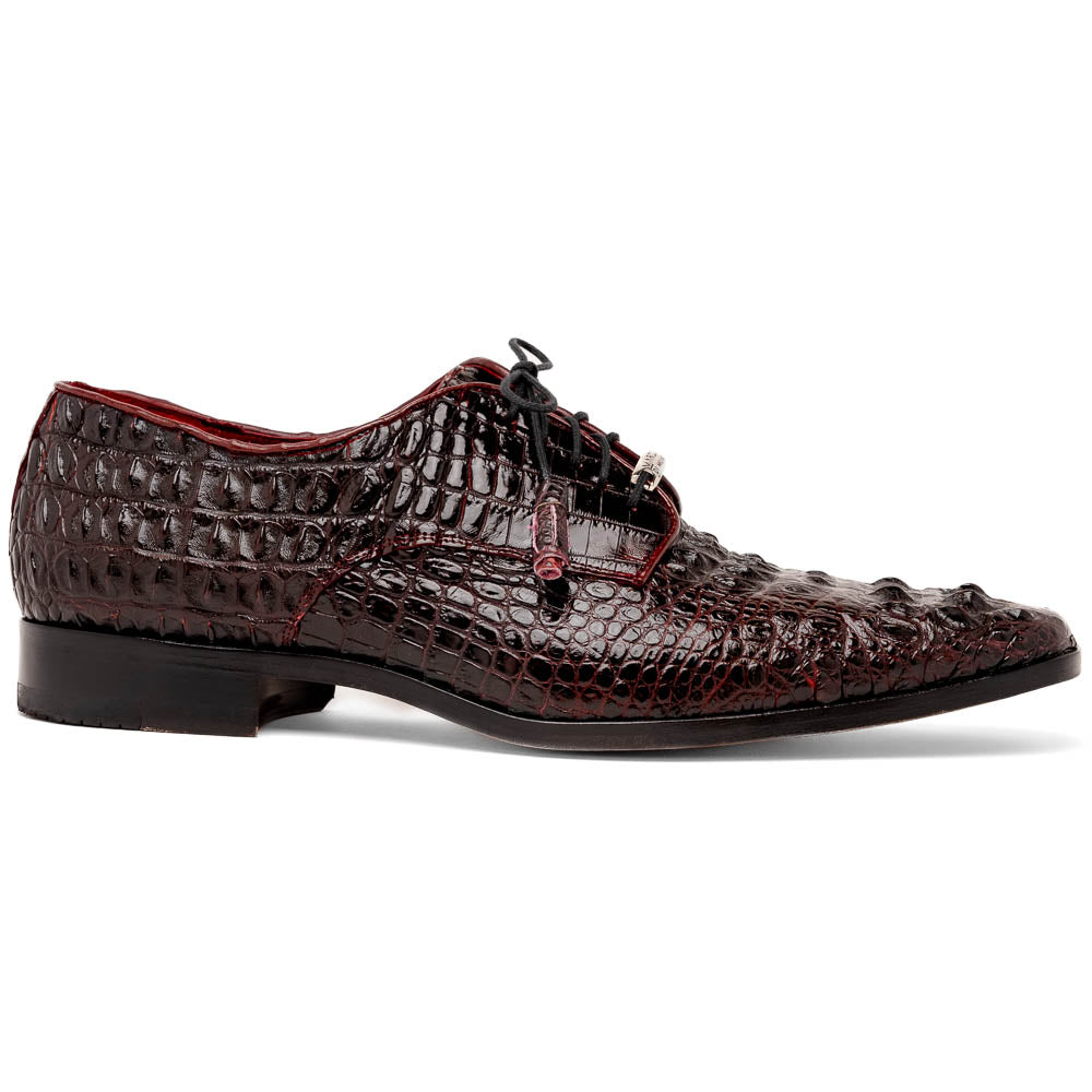 The Marco Di Milano Nilo Wine shoes are luxury dress footwear crafted from dark brown, textured Italian leather, featuring red interior lining and tan leather soles, with one shoe stylishly propped on the other.