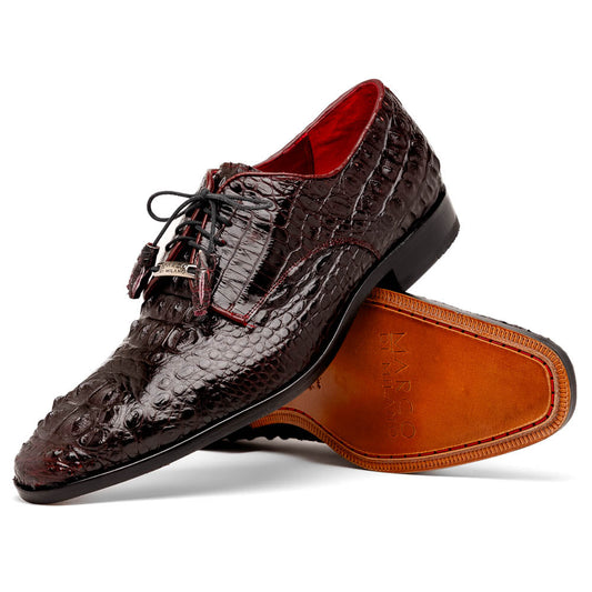 The Marco Di Milano Nilo Wine shoes are luxury dress footwear crafted from dark brown, textured Italian leather, featuring red interior lining and tan leather soles, with one shoe stylishly propped on the other.