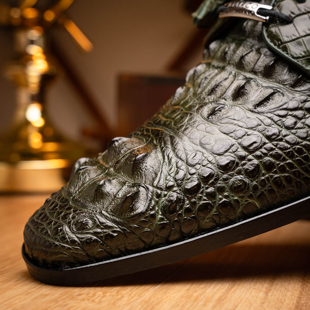 The Nilo Forest Green by Marco Di Milano is a luxury pair crafted from premium Nile crocodile skin in green, with black laces—one shoe upright, the other showing a branded brown leather sole.
