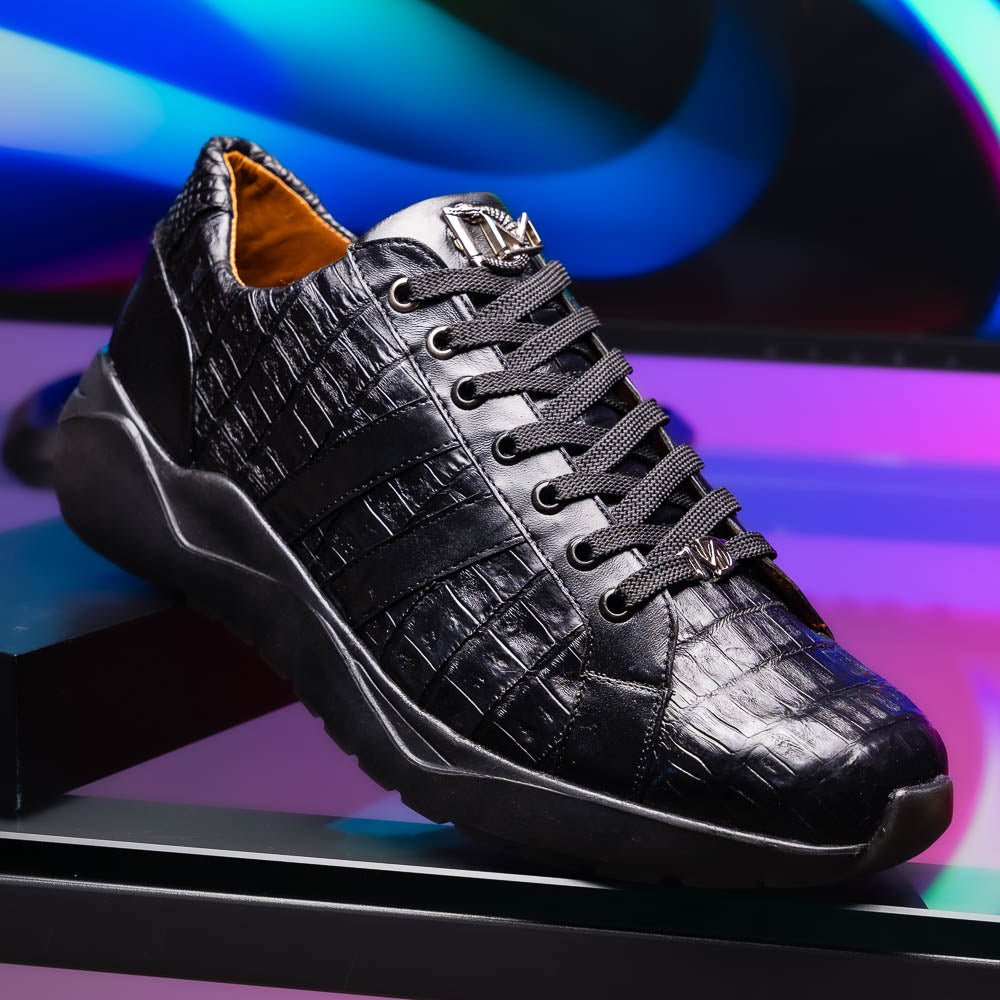 The Nino Black by Marco Di Milano: genuine black caiman crocodile sneakers with black laces and a textured rubber sole, one standing and one leaning, highlighting luxury footwear with a striking hand painted finish.
