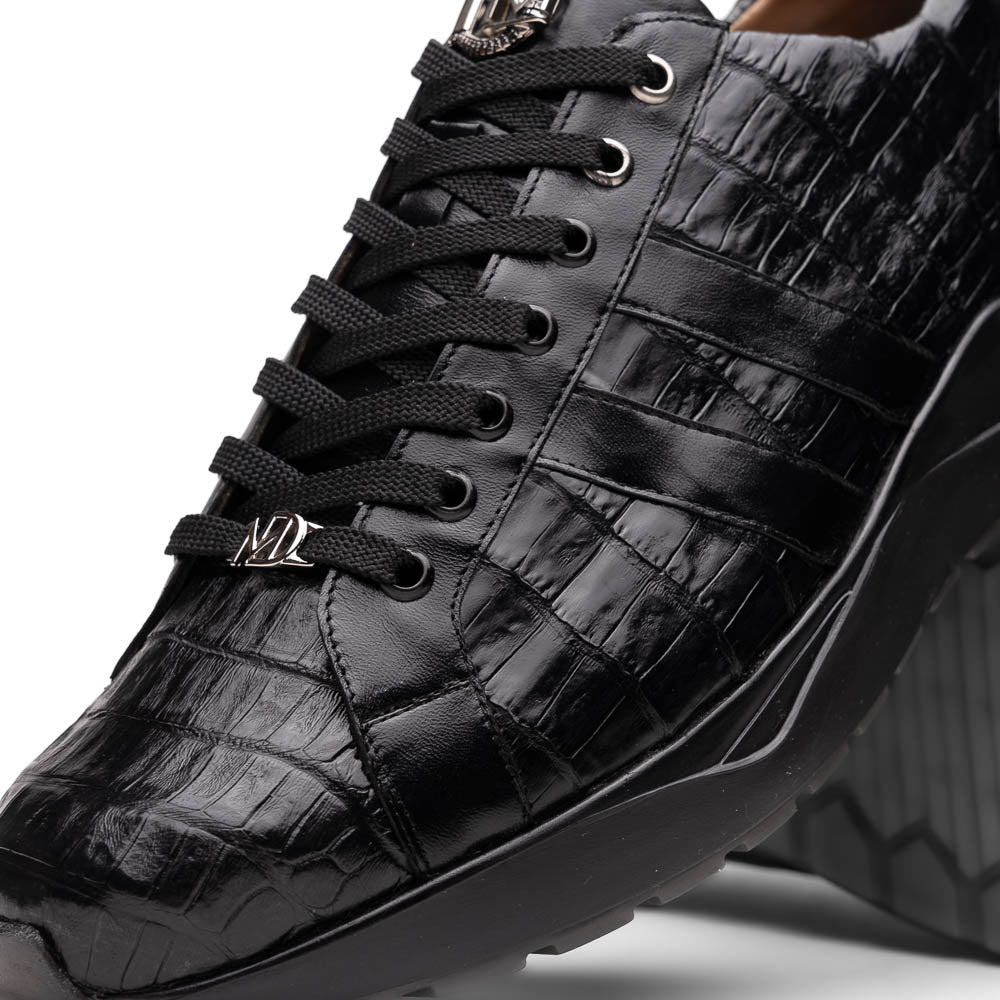 The Nino Black by Marco Di Milano: genuine black caiman crocodile sneakers with black laces and a textured rubber sole, one standing and one leaning, highlighting luxury footwear with a striking hand painted finish.