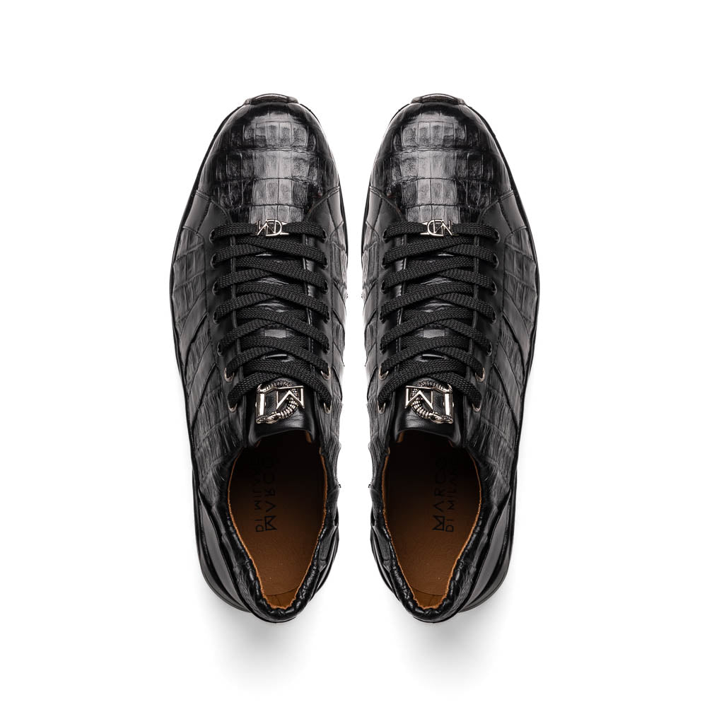 The Nino Black by Marco Di Milano: genuine black caiman crocodile sneakers with black laces and a textured rubber sole, one standing and one leaning, highlighting luxury footwear with a striking hand painted finish.