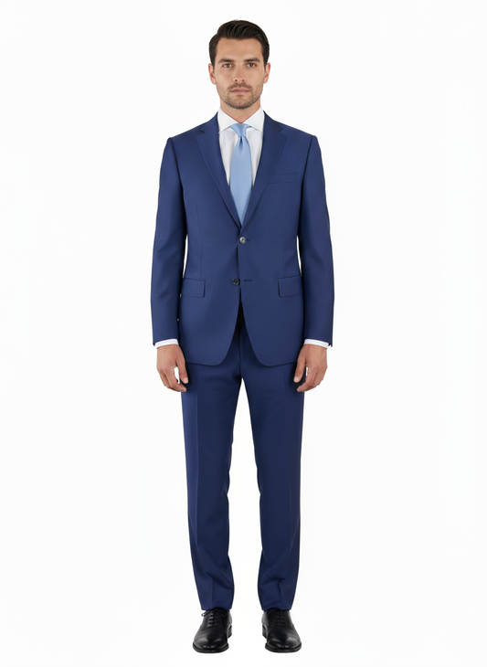 A man stands facing forward against a plain white background, wearing the Tiglio Luxe Novello French Blue Pure Wool Men’s Suit paired with a light blue tie and black shoes.