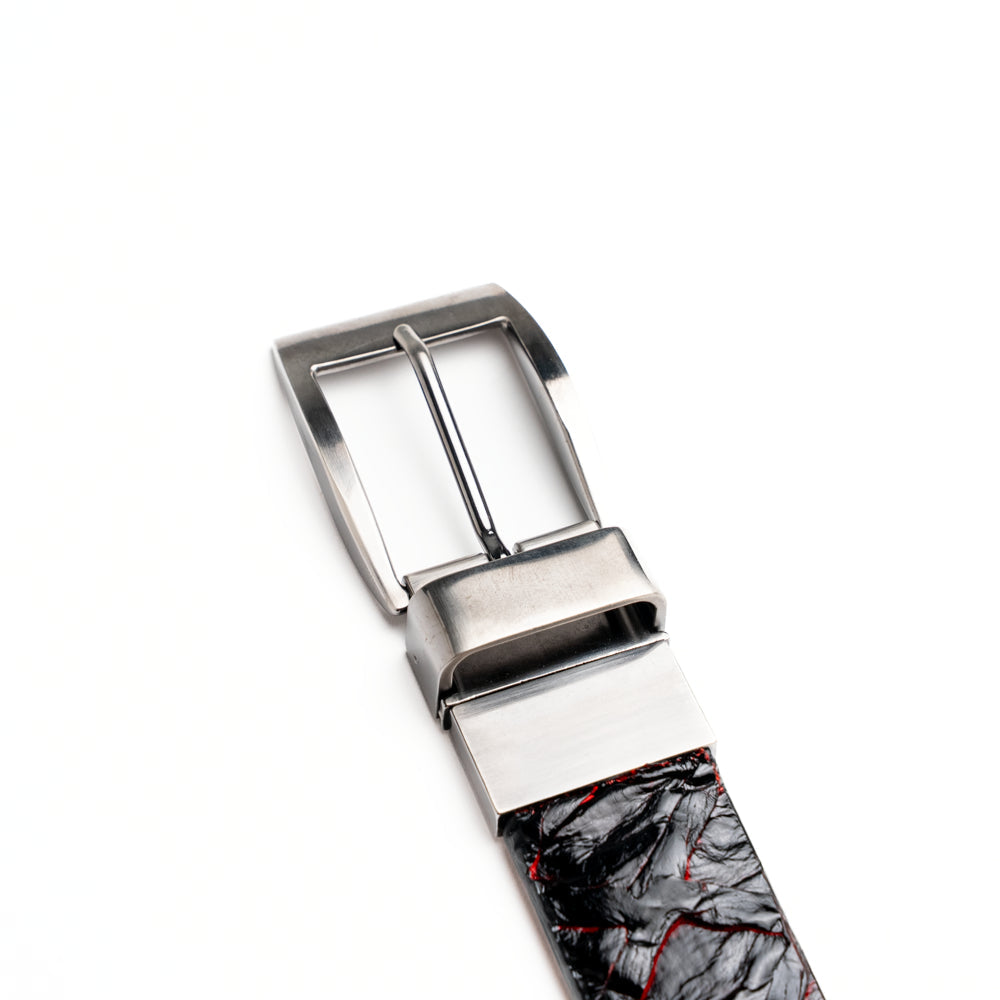 The Olivieri Belt Blackcherry by Marco Di Milano is a luxury men’s accessory crafted from black leather with red textured patterns, rolled up and showcased with a silver rectangular buckle on a white background—making it an exquisite exotic leather belt choice for any sophisticated wardrobe.