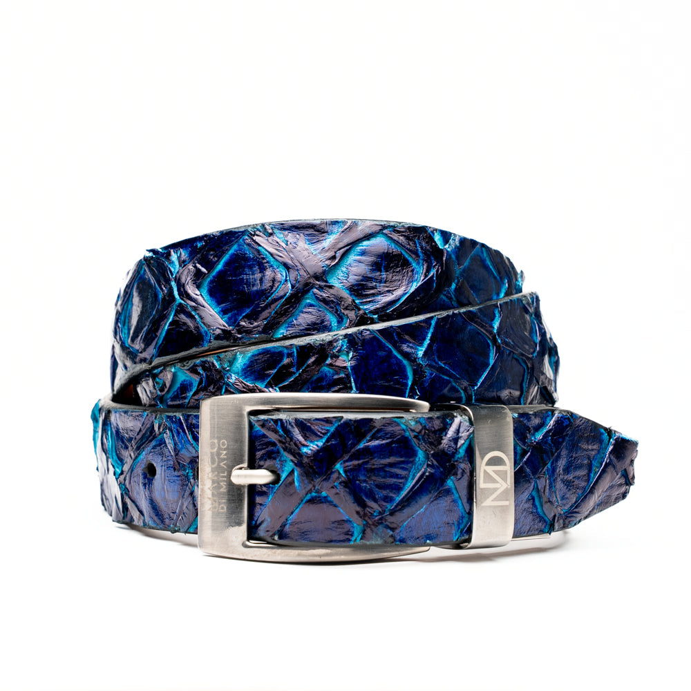The Olivieri Belt Royal Blue by Marco Di Milano, featuring blue textured genuine pirarucu leather and a silver buckle, is coiled elegantly against a white background—an exquisite example of an exotic belt designed for the discerning gentleman.