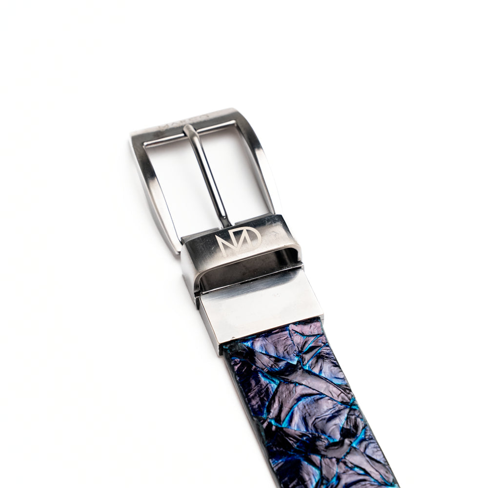 The Olivieri Belt Royal Blue by Marco Di Milano, featuring blue textured genuine pirarucu leather and a silver buckle, is coiled elegantly against a white background—an exquisite example of an exotic belt designed for the discerning gentleman.