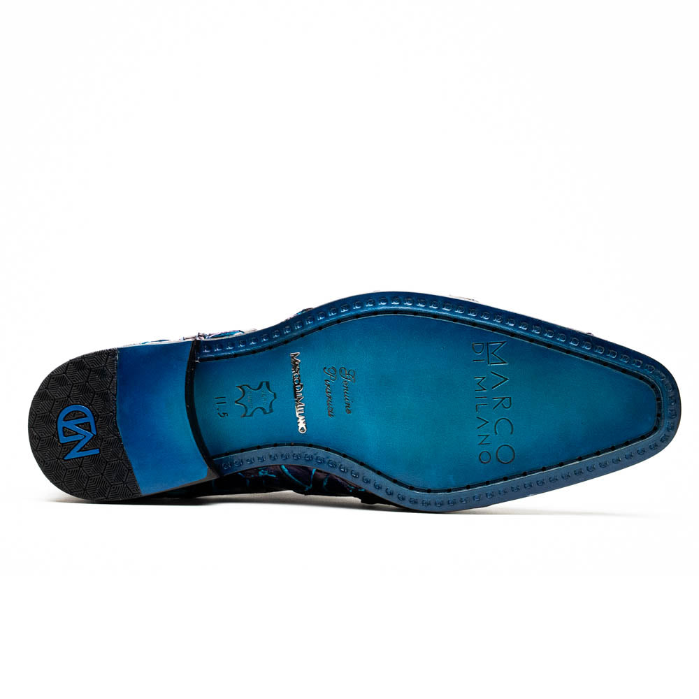 The Olivieri Royal Blue by Marco Di Milano is a pair of men's dress shoes featuring a blue and black textured design. One shoe stands upright, the other displays a bright blue sole with "Marco Di Milano" branding—true luxury.