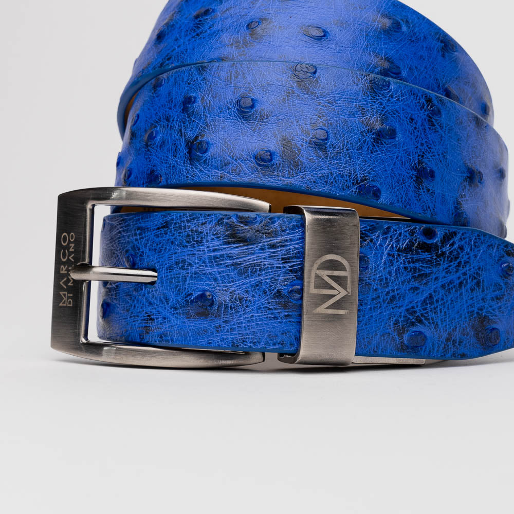The Domenico Belt Electric Blue by Marco Di Milano features textured leather and a silver "MD" engraved buckle, pairing perfectly with luxury footwear. Experience sophistication inspired by classic ostrich belts.