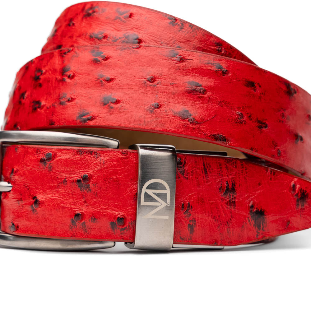 The Domenico Belt Red by Marco Di Milano is a red ostrich leather belt with black spots, finished with a silver rectangular buckle engraved with the brand's logo—an elegant match for Marco Di Milano luxury footwear.