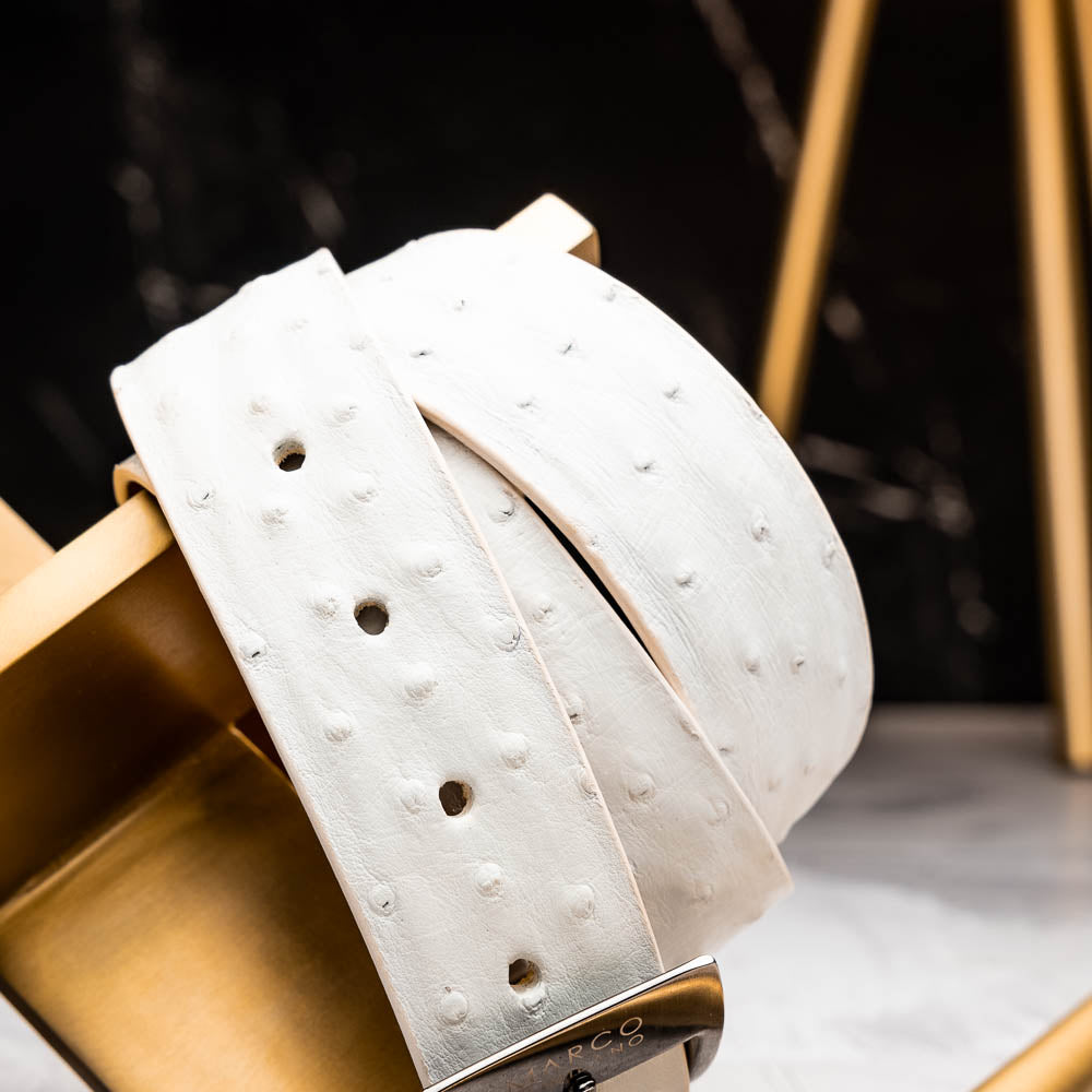 The Domenico Belt White by Marco Di Milano is a white leather belt with a silver buckle, subtle ostrich-inspired texture, and embossed Marco Di Milano branding on the strap and buckle.