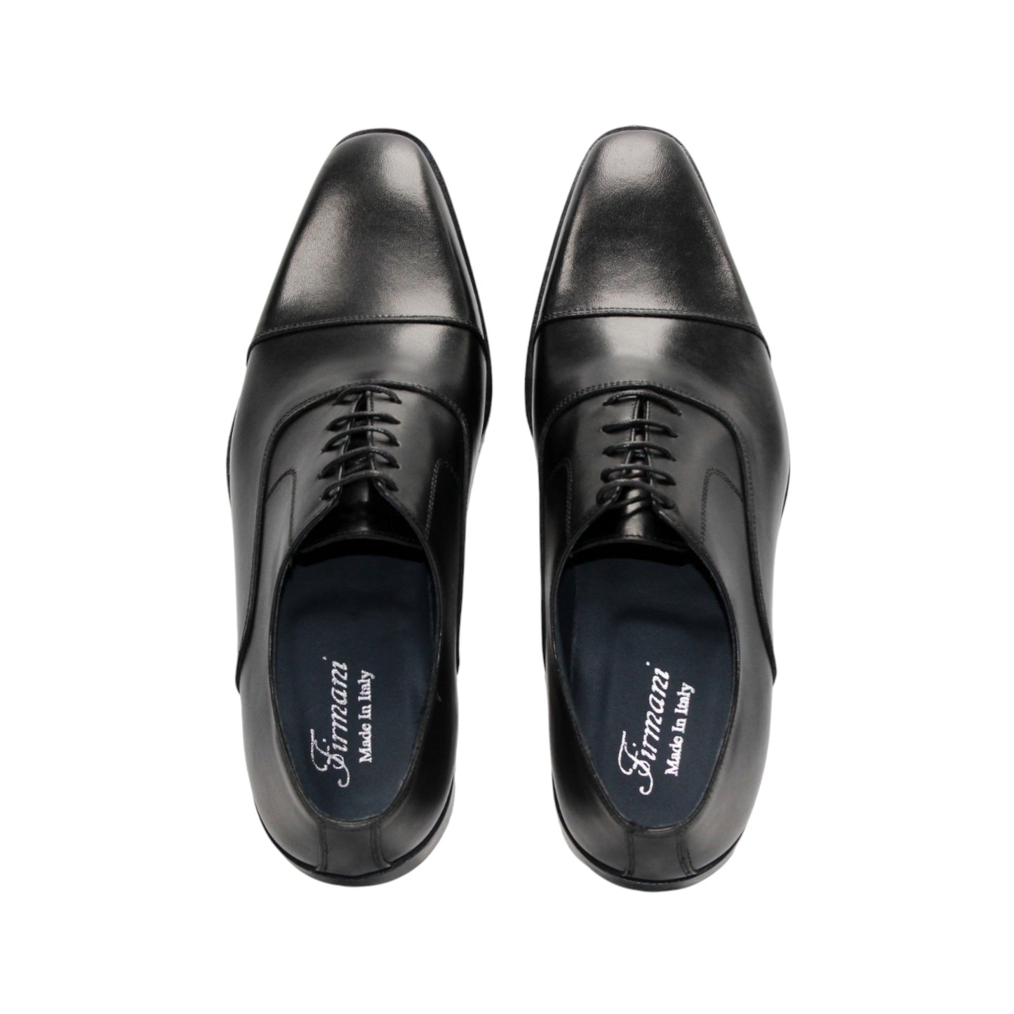 The Firmani Owen Black by Firmani is a genuine leather oxford dress shoe with a cap toe, laces, and low stacked heel, shown in profile on a white background—an icon of timeless style.