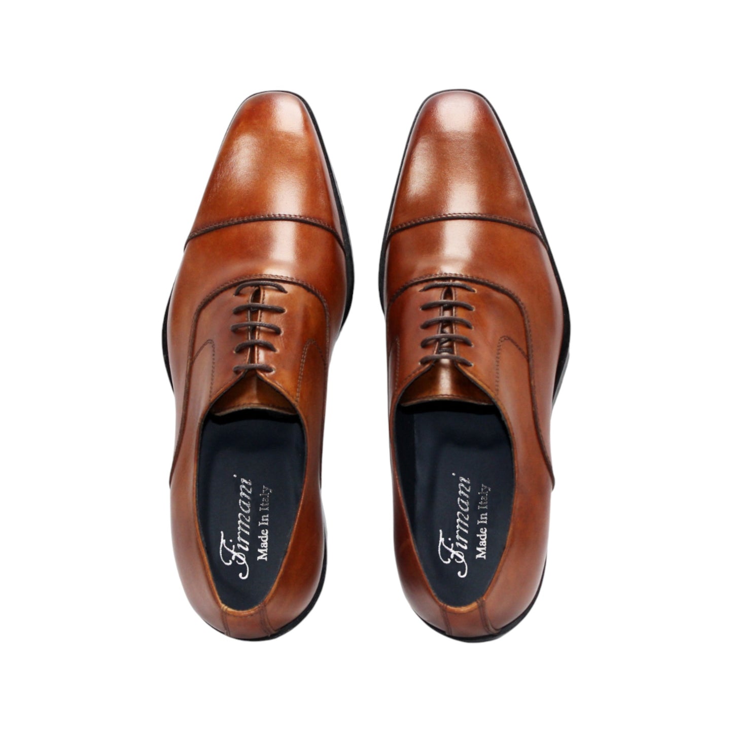 The Firmani Owen Cognac by Firmani is a brown genuine leather oxford dress shoe with a black sole, shown in a side view on a plain white background—ideal for timeless style enthusiasts.