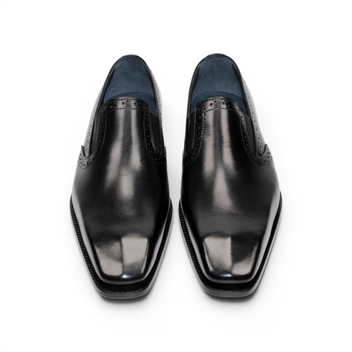 The Duca Di Matiste Duca Paliano Black is an Italian-made slip-on dress shoe in premium black calf leather, featuring a low heel and decorative perforations, shown in profile for timeless style.