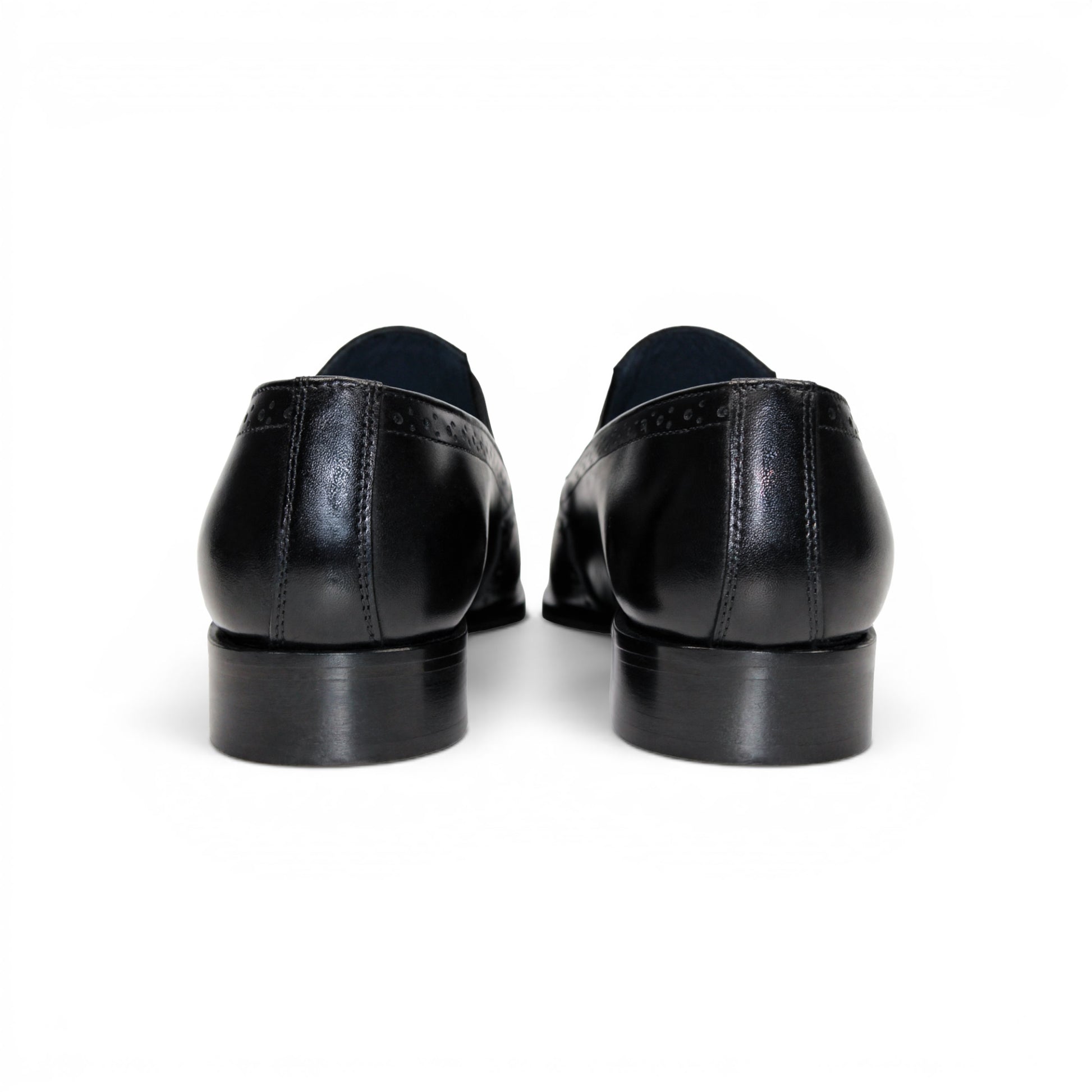The Duca Di Matiste Duca Paliano Black is an Italian-made slip-on dress shoe in premium black calf leather, featuring a low heel and decorative perforations, shown in profile for timeless style.