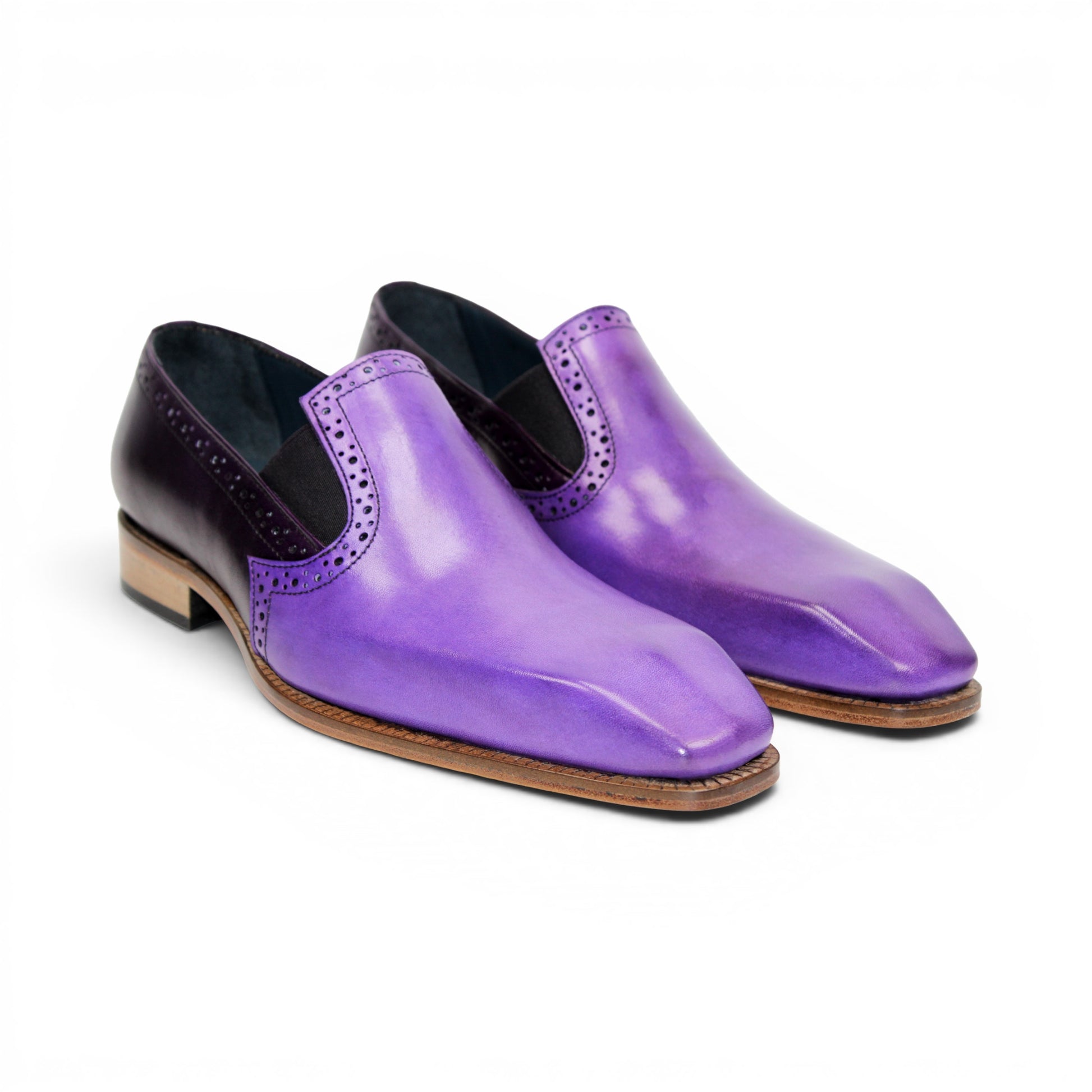 The Duca Di Matiste Duca Paliano Lavender/Purple is an Italian-made men's slip-on dress shoe in purple calf leather, with a darker purple heel, black elastic inserts, and a light brown sole for timeless style.