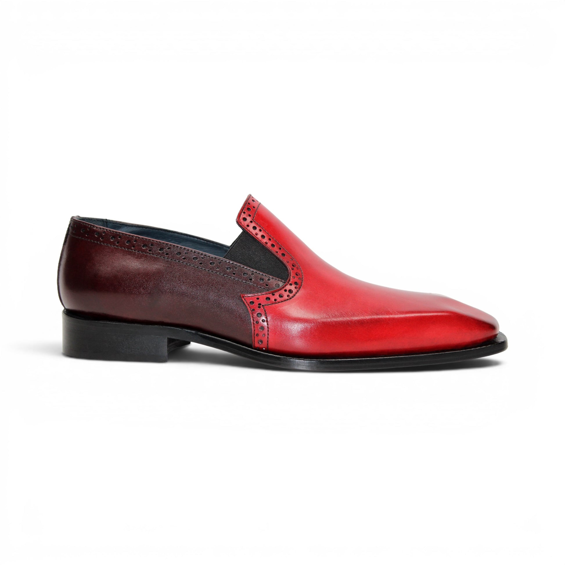 The Duca Di Matiste Duca Paliano Red/Burgundy is a men’s slip-on dress shoe in fine calf leather, featuring a red and dark brown upper with decorative perforations and a black low heel—Italian-made timeless style.