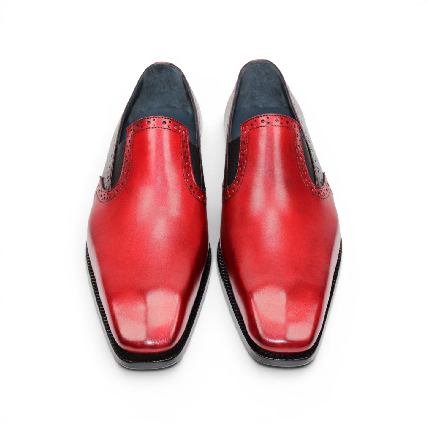 The Duca Di Matiste Duca Paliano Red/Burgundy is a men’s slip-on dress shoe in fine calf leather, featuring a red and dark brown upper with decorative perforations and a black low heel—Italian-made timeless style.