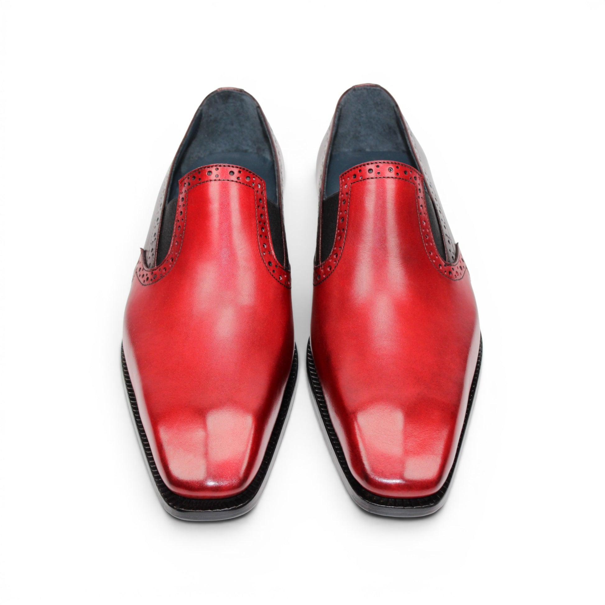 The Duca Di Matiste Duca Paliano Red/Burgundy is a men’s slip-on dress shoe in fine calf leather, featuring a red and dark brown upper with decorative perforations and a black low heel—Italian-made timeless style.