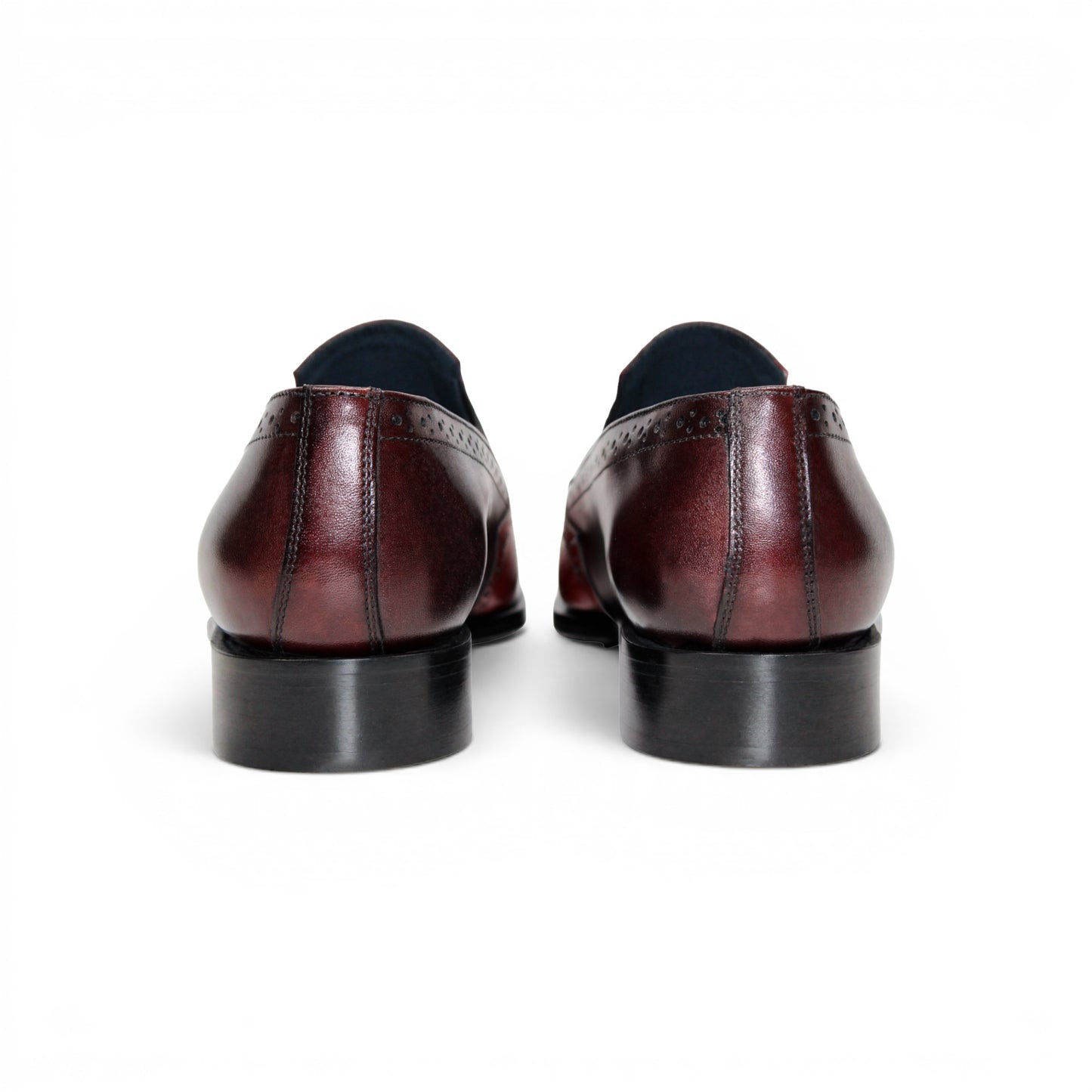 The Duca Di Matiste Duca Paliano Red/Burgundy is a men’s slip-on dress shoe in fine calf leather, featuring a red and dark brown upper with decorative perforations and a black low heel—Italian-made timeless style.