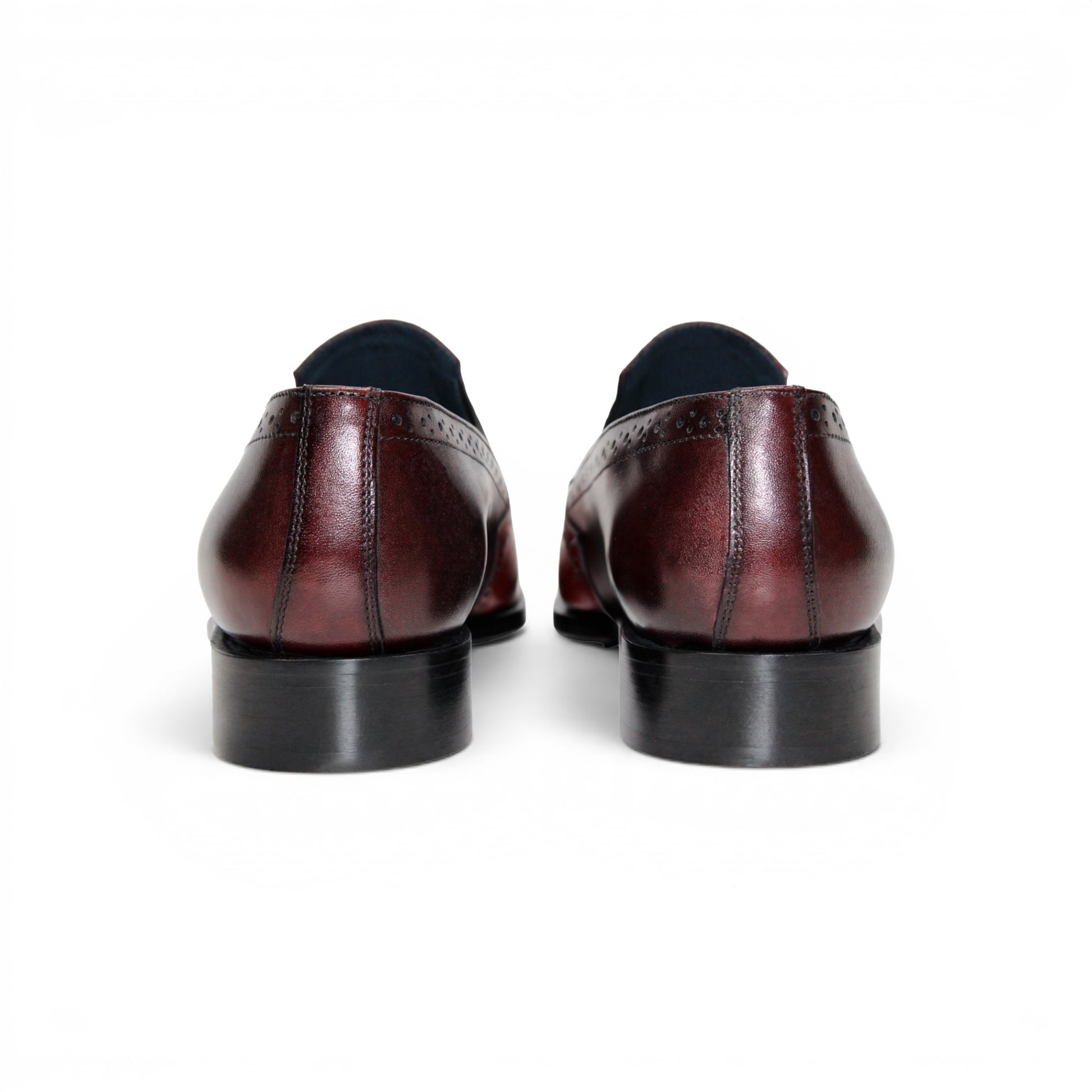 The Duca Di Matiste Duca Paliano Red/Burgundy is a men’s slip-on dress shoe in fine calf leather, featuring a red and dark brown upper with decorative perforations and a black low heel—Italian-made timeless style.