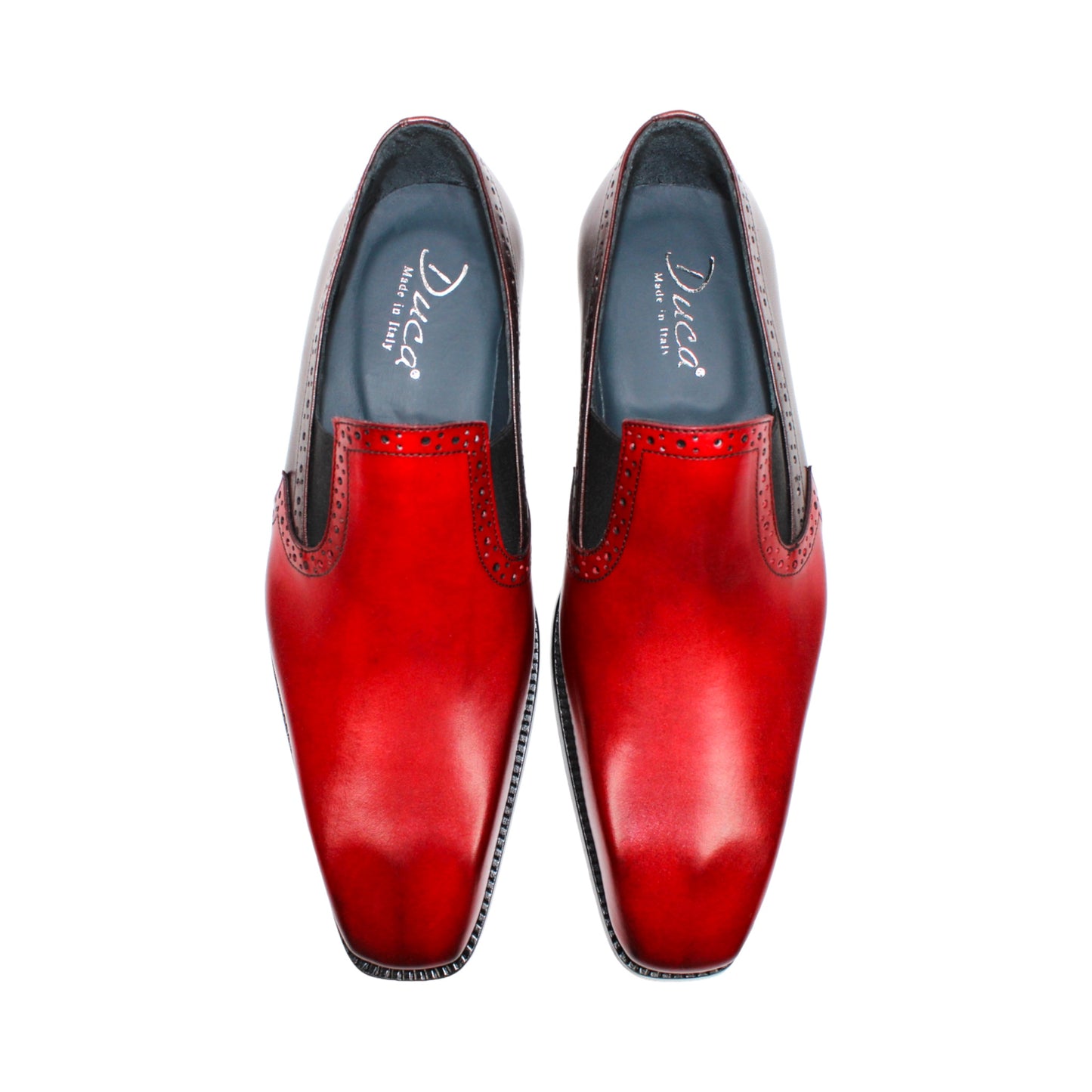 The Duca Di Matiste Duca Paliano Red/Burgundy is a men’s slip-on dress shoe in fine calf leather, featuring a red and dark brown upper with decorative perforations and a black low heel—Italian-made timeless style.