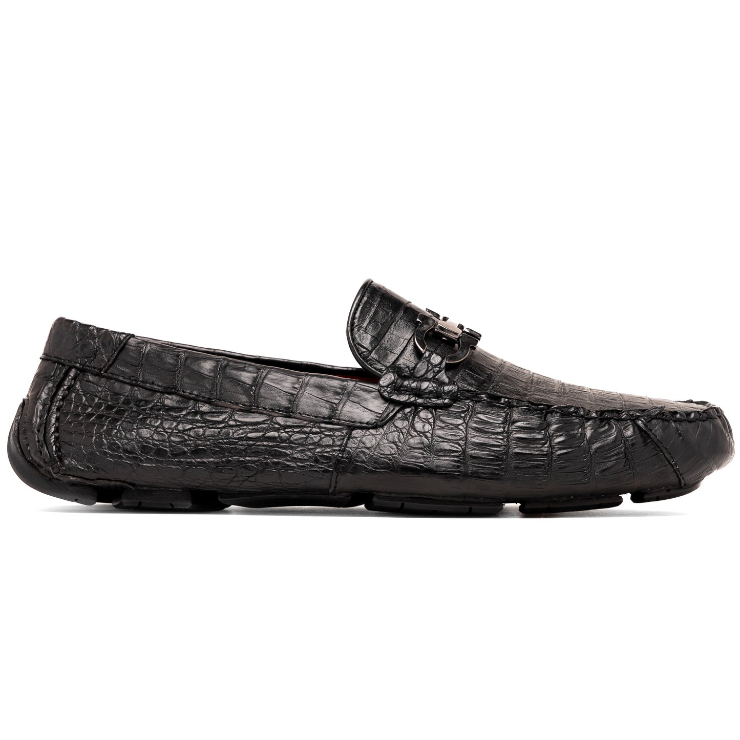 The Marco Di Milano Parma Black is a luxury caiman belly loafer featuring black crocodile-textured leather, metal buckle accents, and rubber soles, with one men’s driving shoe upright and the other leaning against it.