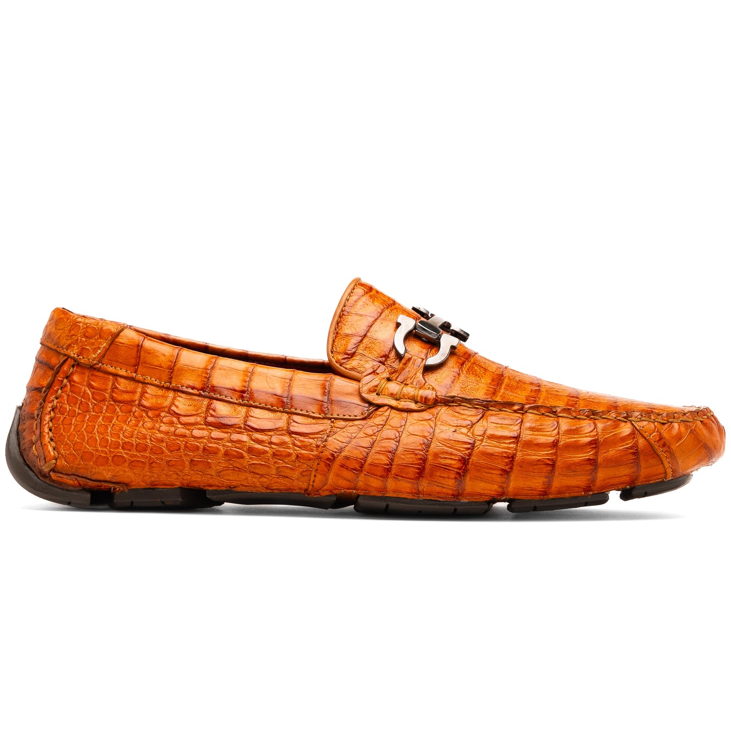 Marco Di Milano’s Parma Brandy loafers feature an orange crocodile pattern, black metal buckles, and hand-painted finishes—one shoe stands upright while the other lies on its side to reveal the detailed sole.