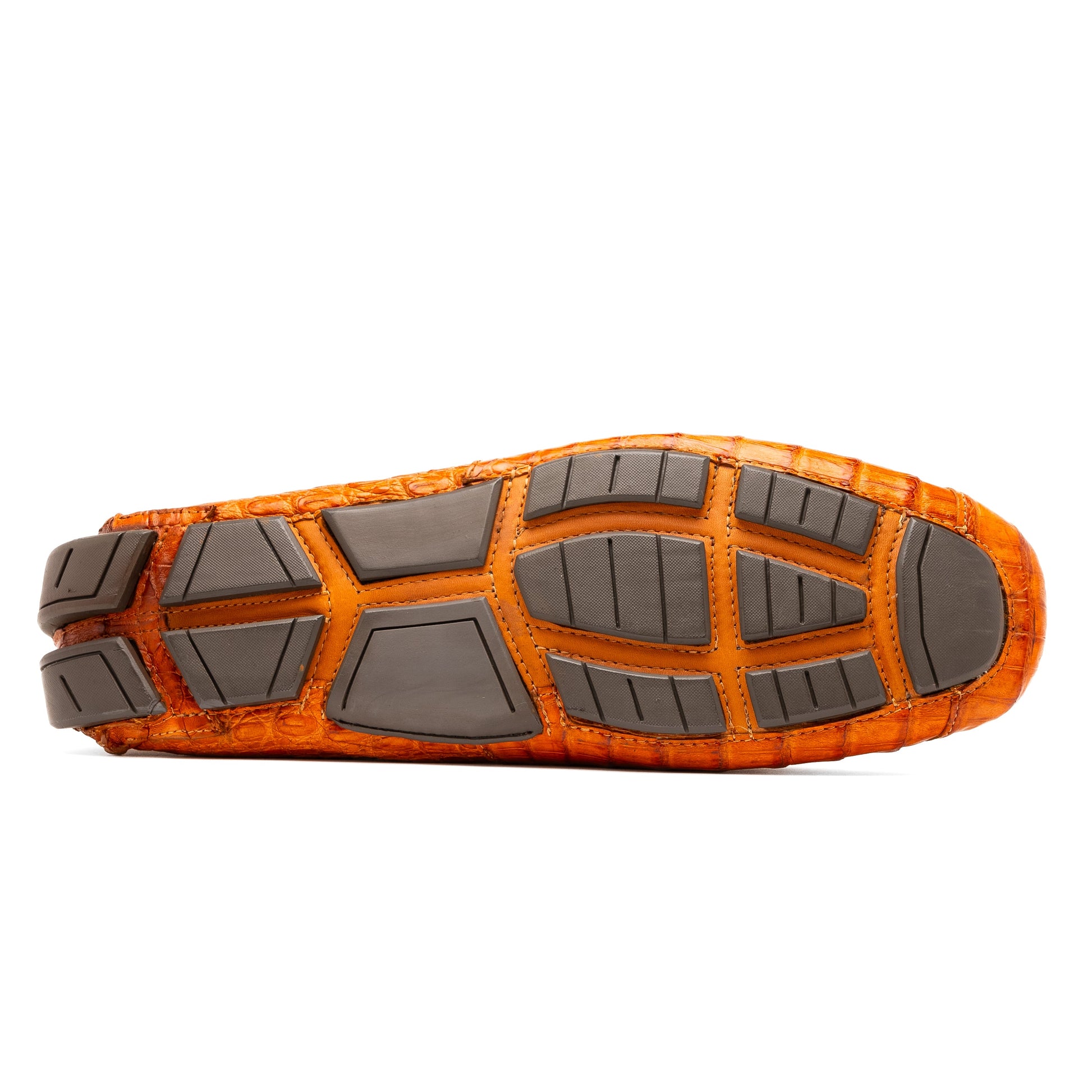 Marco Di Milano’s Parma Brandy loafers feature an orange crocodile pattern, black metal buckles, and hand-painted finishes—one shoe stands upright while the other lies on its side to reveal the detailed sole.