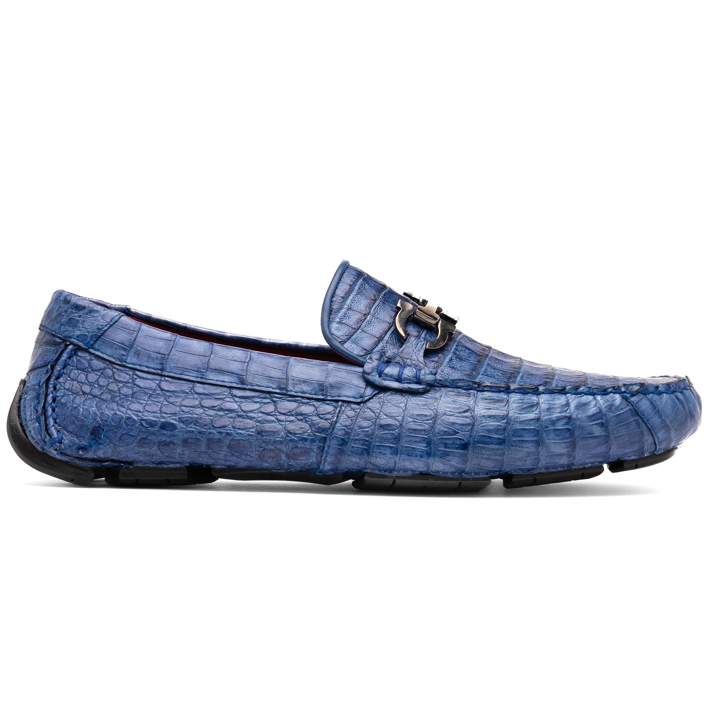 The Marco Di Milano Parma Blue Jeans loafers feature genuine blue caiman leather with a crocodile pattern, metal hardware accents, and rubber soles—ideal luxury footwear, displayed with one shoe upright and the other on its side.