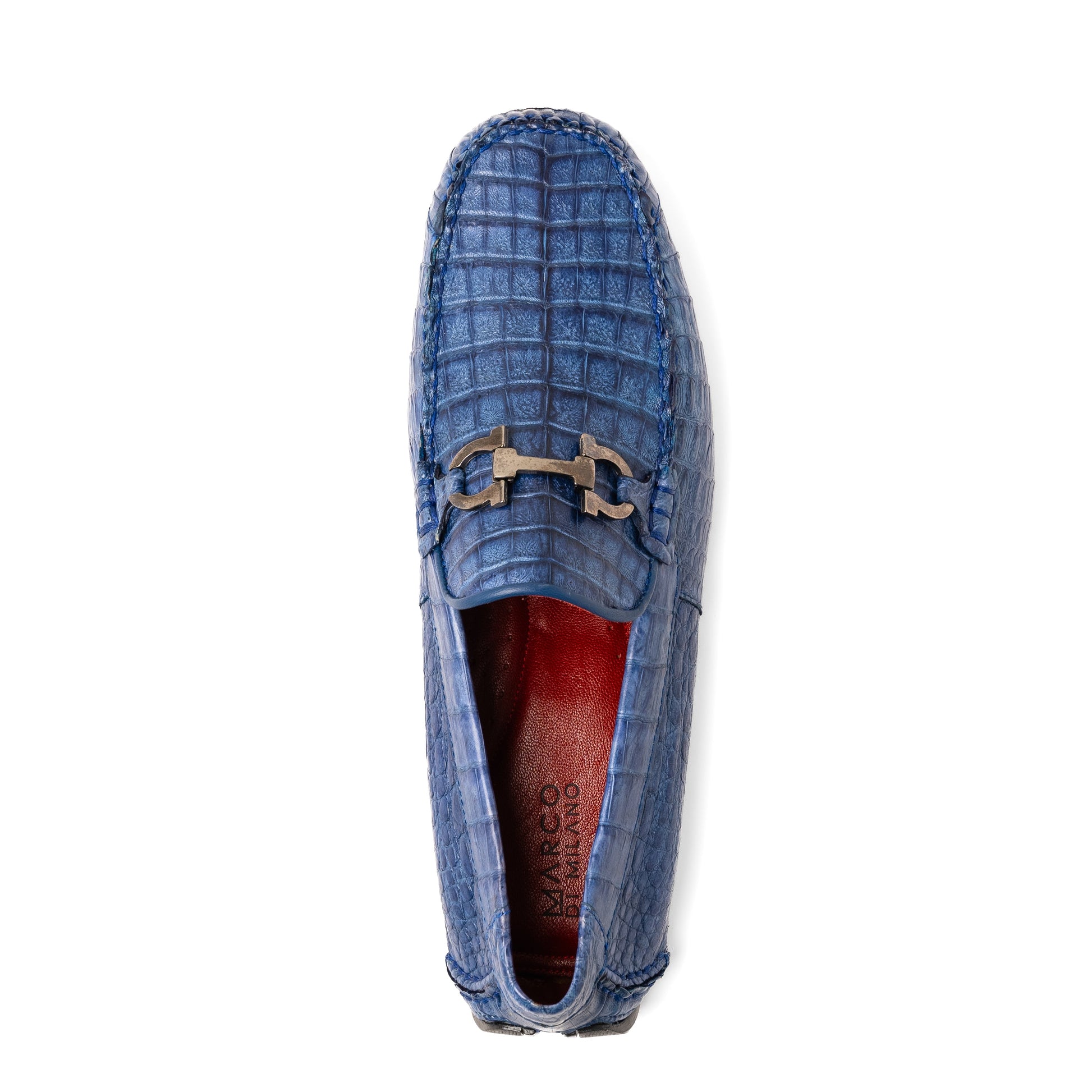 The Marco Di Milano Parma Blue Jeans loafers feature genuine blue caiman leather with a crocodile pattern, metal hardware accents, and rubber soles—ideal luxury footwear, displayed with one shoe upright and the other on its side.