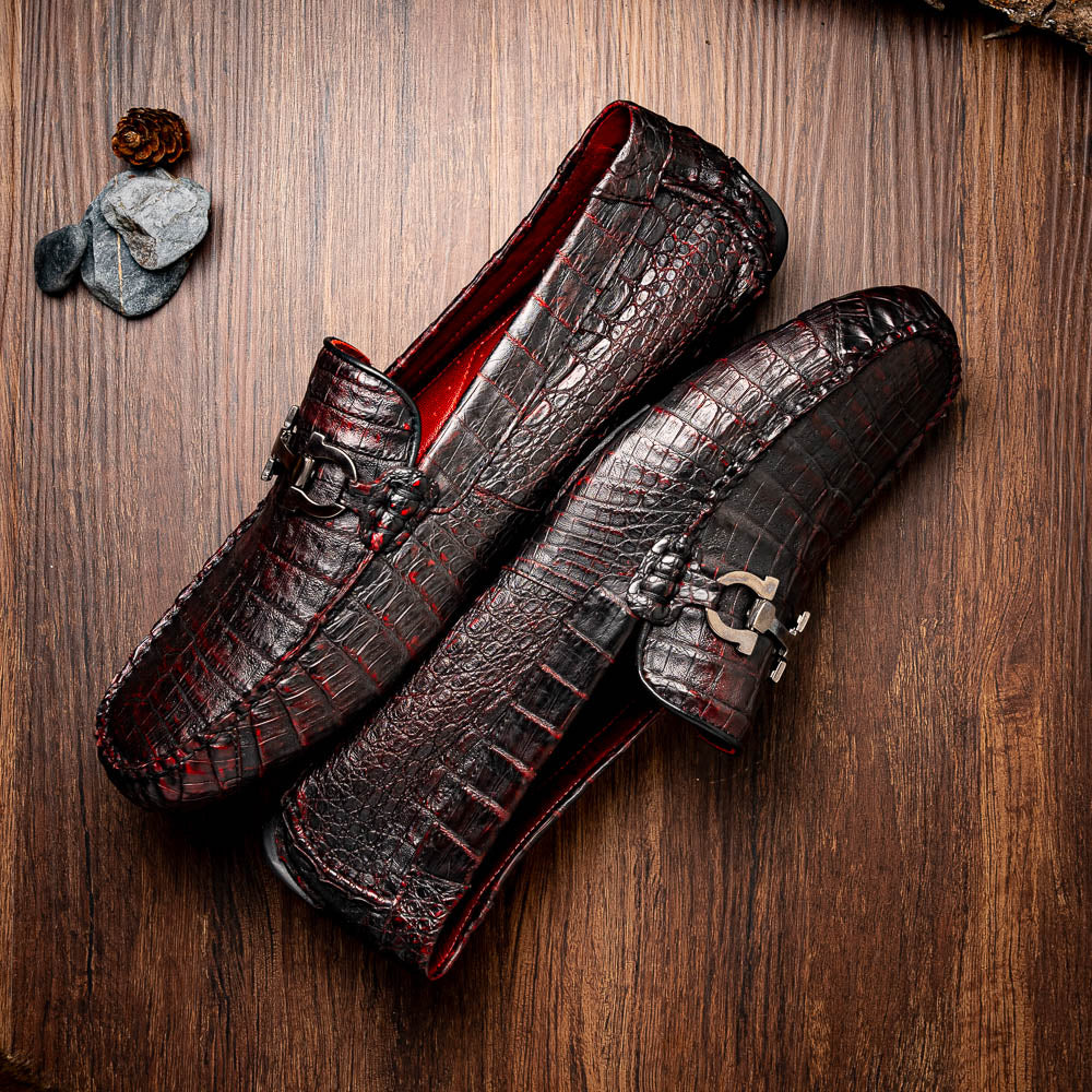 The Marco Di Milano Parma Blackcherry loafers feature genuine caiman leather with a crocodile pattern and metal buckle detail—luxury men's slip-ons shown upright and angled to display the sole, designed for effortless elegance.