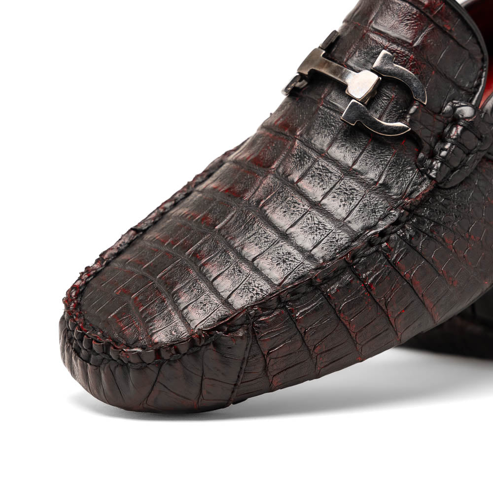 The Marco Di Milano Parma Blackcherry loafers feature genuine caiman leather with a crocodile pattern and metal buckle detail—luxury men's slip-ons shown upright and angled to display the sole, designed for effortless elegance.