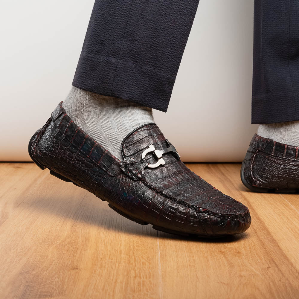 The Marco Di Milano Parma Blackcherry loafers feature genuine caiman leather with a crocodile pattern and metal buckle detail—luxury men's slip-ons shown upright and angled to display the sole, designed for effortless elegance.