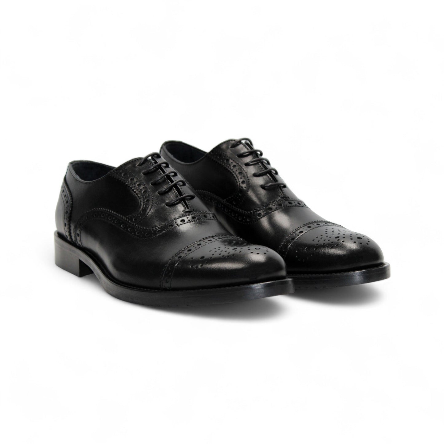 The Firmani Paul Black by Firmani is a black genuine leather oxford dress shoe with brogue detailing, laces, and a low heel, shown from the side against a white background.