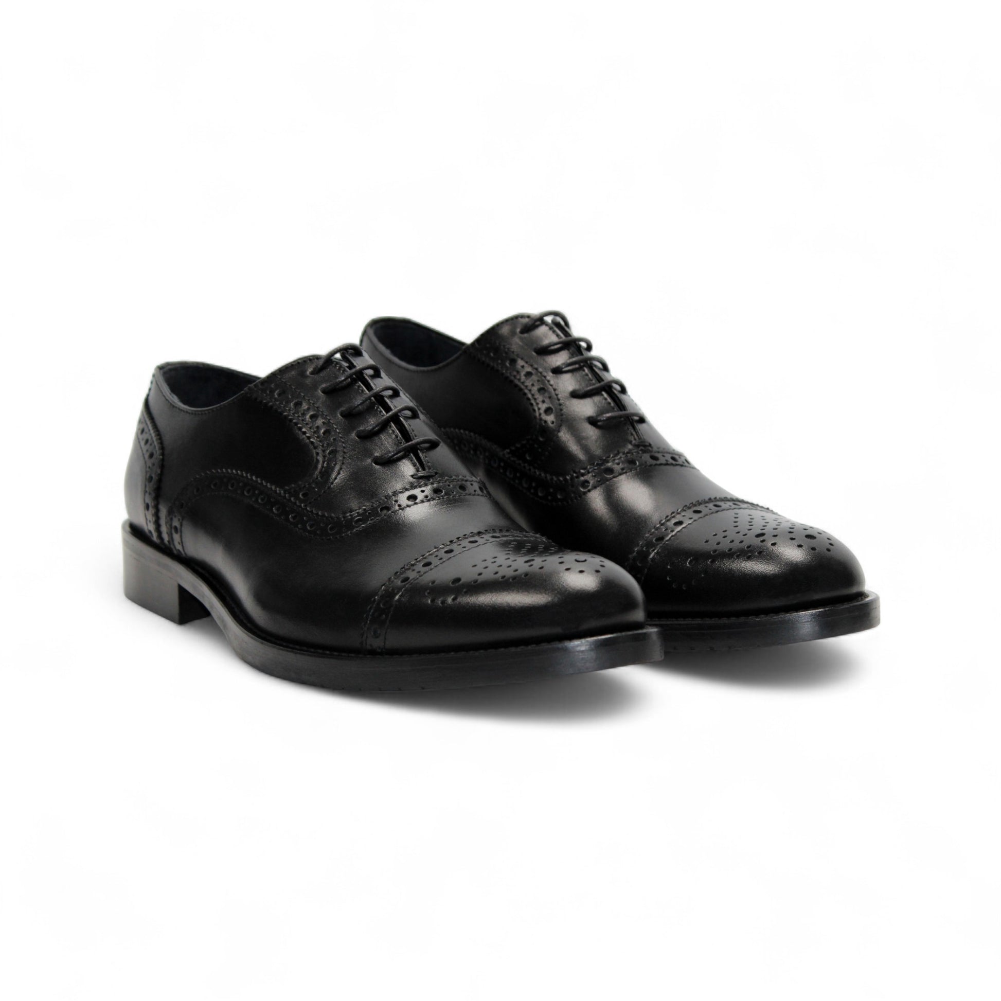The Firmani Paul Black by Firmani is a black genuine leather oxford dress shoe with brogue detailing, laces, and a low heel, shown from the side against a white background.