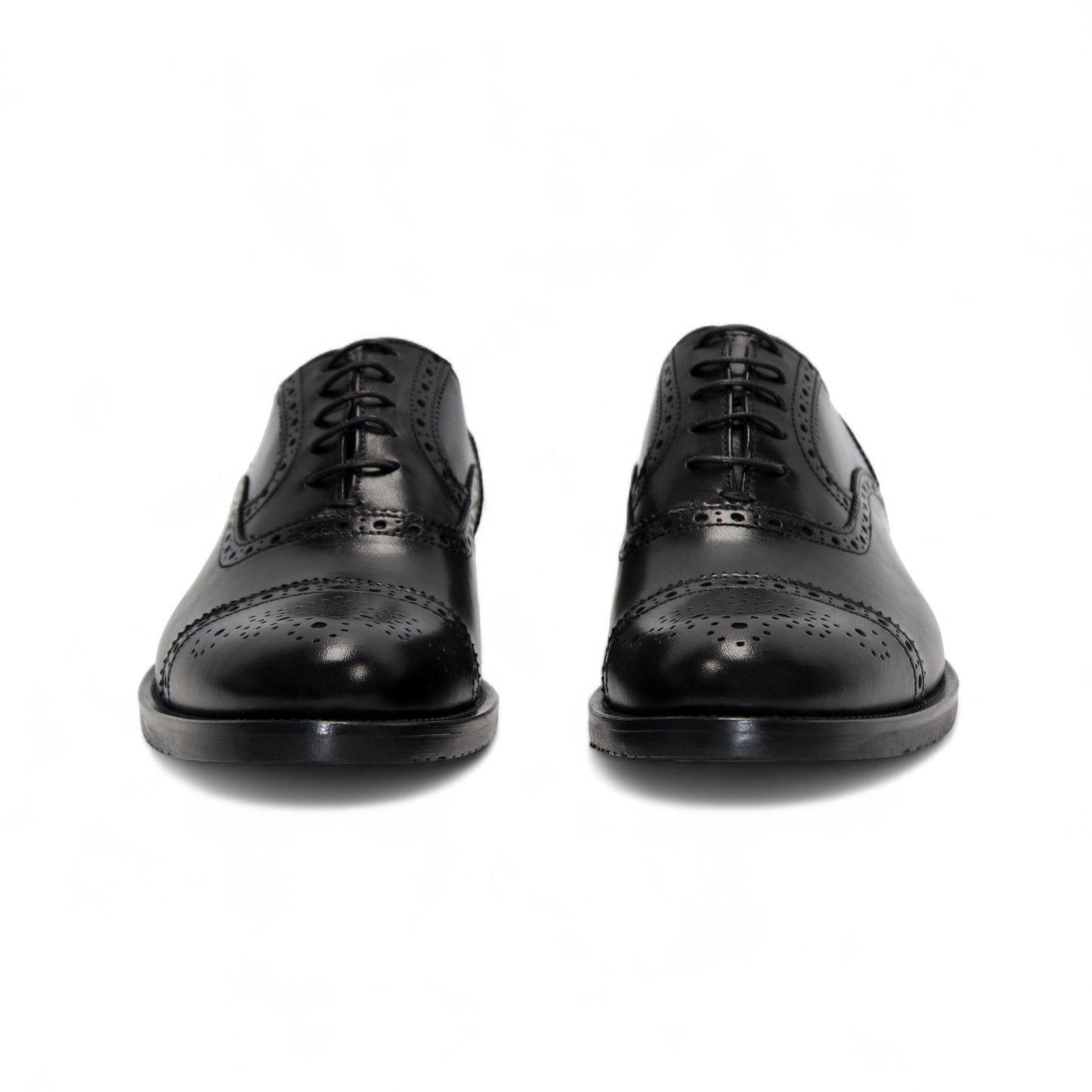 The Firmani Paul Black by Firmani is a black genuine leather oxford dress shoe with brogue detailing, laces, and a low heel, shown from the side against a white background.