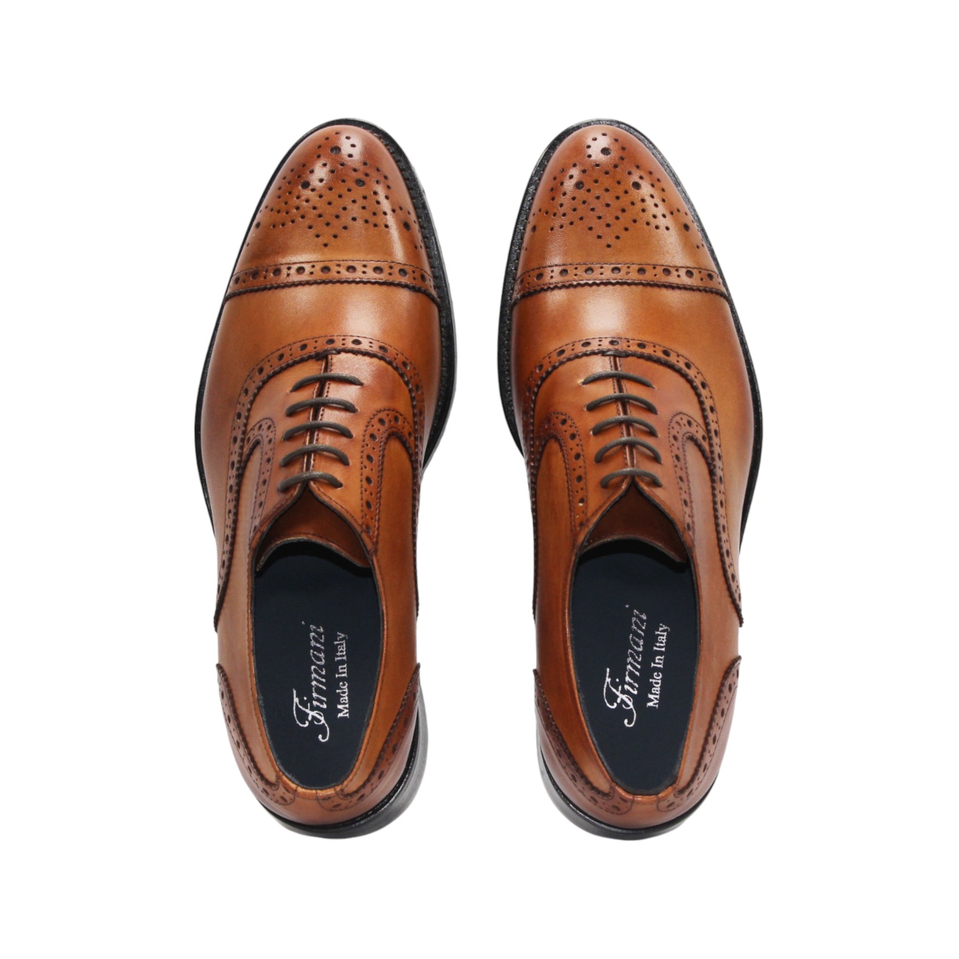 The Firmani Paul Cognac men's dress shoe by Firmani features genuine leather, decorative brogue detailing, black sole, and laces, displayed in a side profile view on a white background.