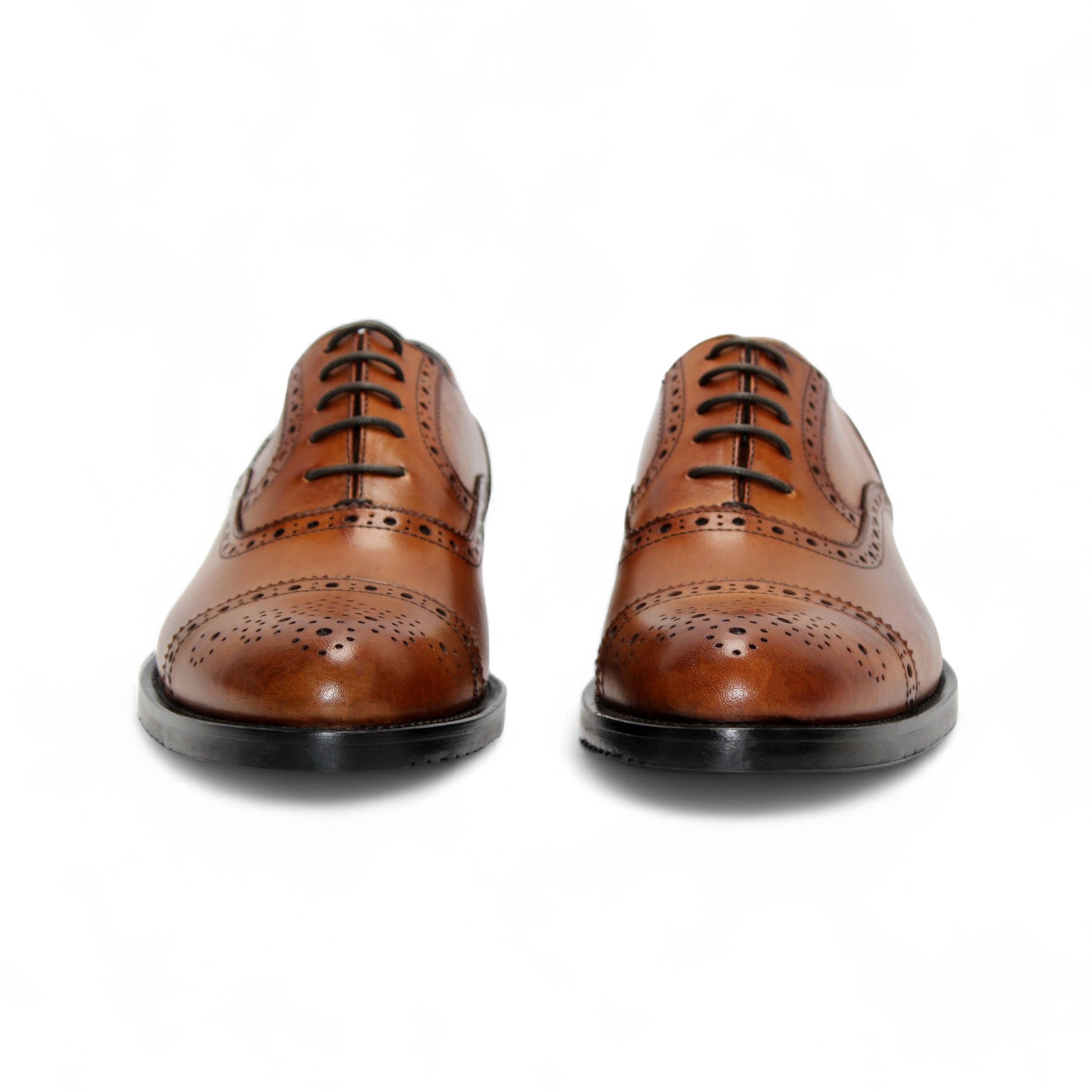 The Firmani Paul Cognac men's dress shoe by Firmani features genuine leather, decorative brogue detailing, black sole, and laces, displayed in a side profile view on a white background.