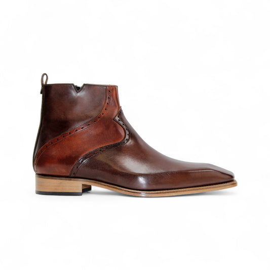 The Duca Di Matiste Duca Pedaso Chocolate/Brandy ankle boot features genuine leather, decorative stitching, a low wooden heel, and a side zipper for timeless style, shown here on a white background.